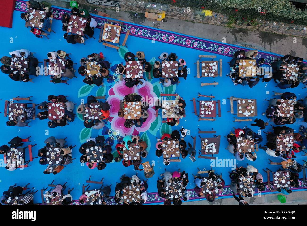 191016 -- HANGZHOU, Oct. 16, 2019 -- Aerial photo taken on Oct. 16, 2019 shows local villagers and tourists enjoying the long-table banquet held at Longfeng ethnic village in Eshan Township of the She ethnic group of Tonglu County, east China s Zhejiang Province. More than 90 tables of delicacies were presented at the long-table banquet, attracting local villagers as well as tourists to enjoy the food of the She ethnic group.  CHINA-ZHEJIANG-ESHAN-LONG-TABLE BANQUET CN HuangxZongzhi PUBLICATIONxNOTxINxCHN Stock Photo