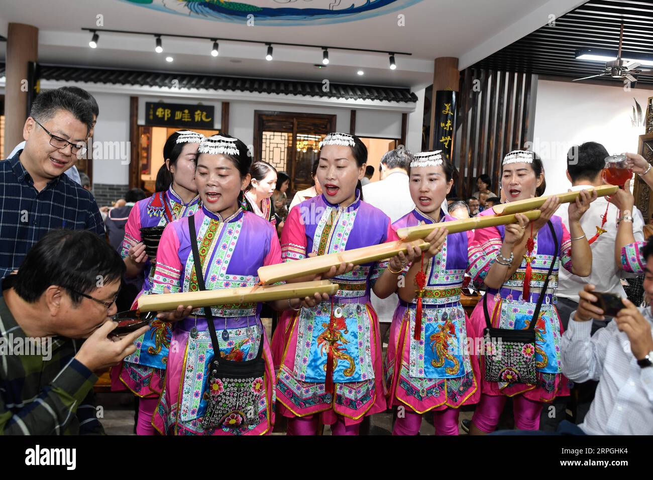 191016 -- HANGZHOU, Oct. 16, 2019 -- Local villagers in traditional costumes of the She ethnic group greet visitors at the long-table banquet held at Longfeng ethnic village in Eshan Township of the She ethnic group of Tonglu County, east China s Zhejiang Province, Oct. 16, 2019. More than 90 tables of delicacies were presented at the long-table banquet, attracting local villagers as well as tourists to enjoy the food of the She ethnic group.  CHINA-ZHEJIANG-ESHAN-LONG-TABLE BANQUET CN HuangxZongzhi PUBLICATIONxNOTxINxCHN Stock Photo