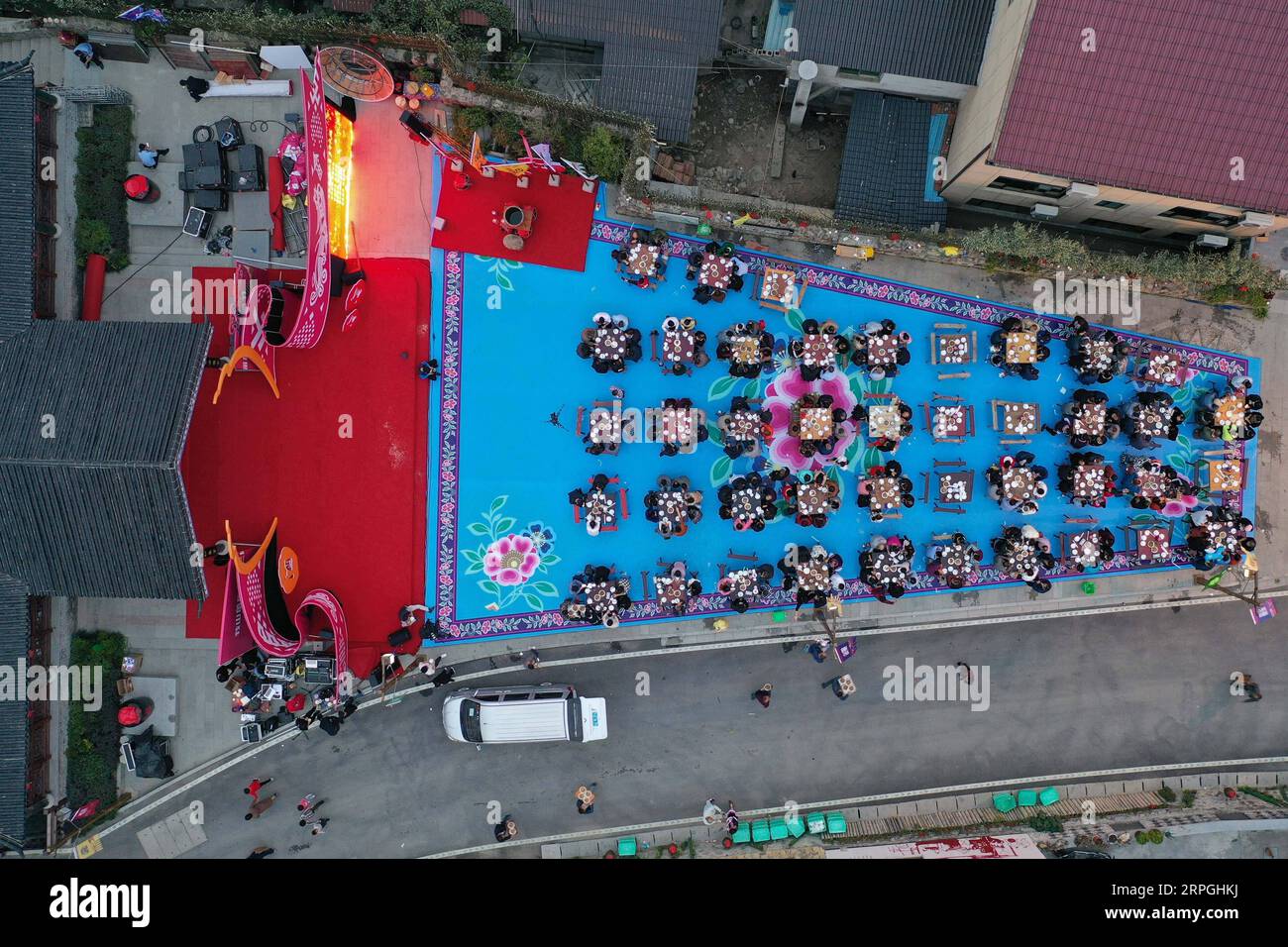 191016 -- HANGZHOU, Oct. 16, 2019 -- Aerial photo taken on Oct. 16, 2019 shows local villagers and tourists enjoying the long-table banquet held at Longfeng ethnic village in Eshan Township of the She ethnic group of Tonglu County, east China s Zhejiang Province. More than 90 tables of delicacies were presented at the long-table banquet, attracting local villagers as well as tourists to enjoy the food of the She ethnic group.  CHINA-ZHEJIANG-ESHAN-LONG-TABLE BANQUET CN HuangxZongzhi PUBLICATIONxNOTxINxCHN Stock Photo