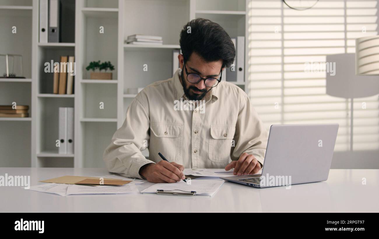 Indian businessman calculate budget money finances Arabian muslim man