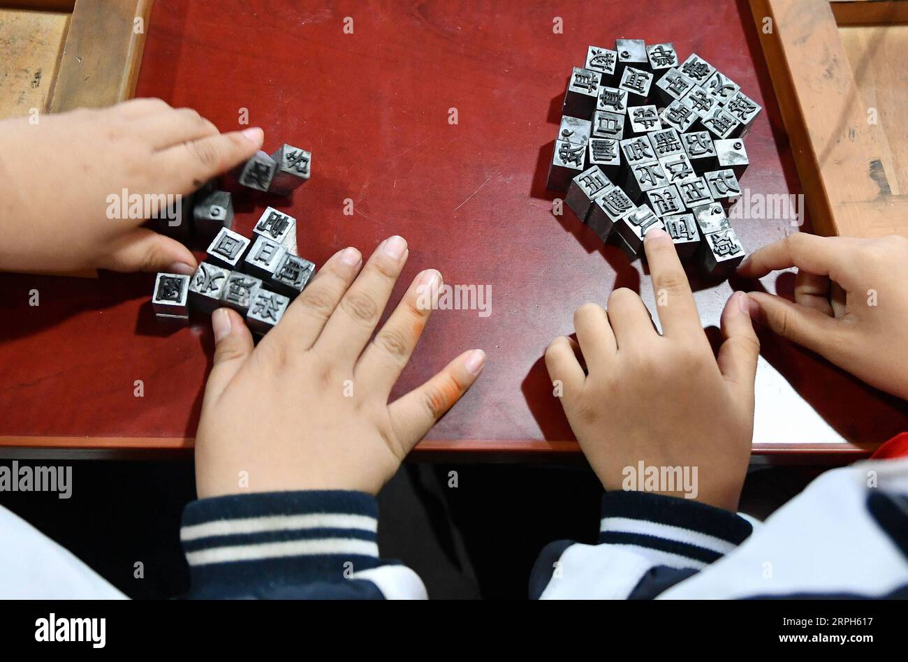 191031 -- JINAN, Oct. 31, 2019 -- Pupils of Xixian primary school experience movable-type printing at Lubei intangible cultural heritage experiencing center in Wudi County, east China s Shandong Province, Oct. 30, 2019. The experiencing center provides a variety of intangible cultural heritage experiencing programs, including the arts of rubbing, ceramics, tie dyeing, paper-making and movable-type printing, aiming to promote traditional Chinese culture through immersive experience.  CHINA-SHANDONG-JINAN-INTANGIBLE CULTURAL HERITAGE-CENTER CN ZhuxZheng PUBLICATIONxNOTxINxCHN Stock Photo