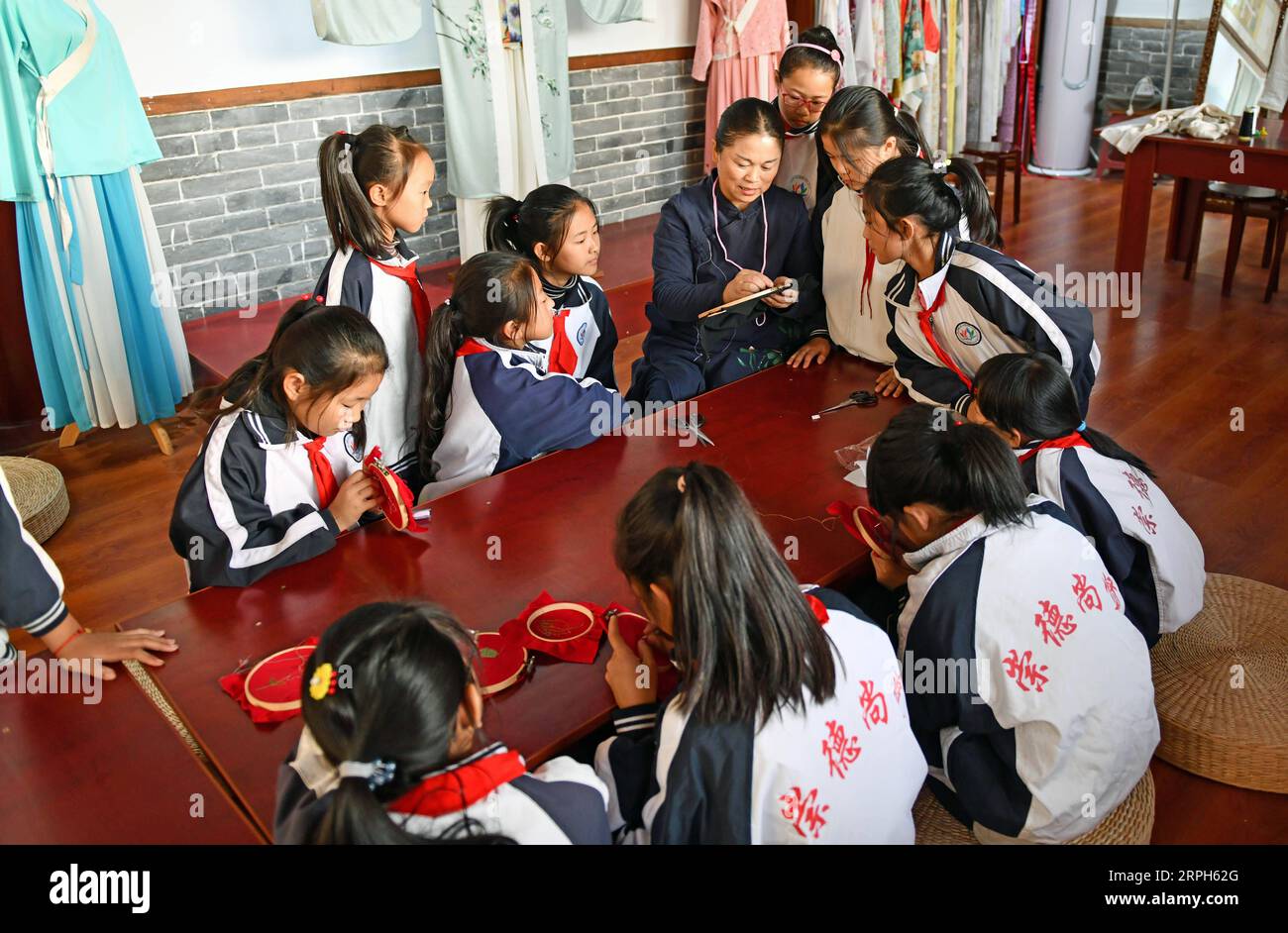 191031 -- JINAN, Oct. 31, 2019 -- Pupils of Xixian primary school learn the embroidery skill at Lubei intangible cultural heritage experiencing center in Wudi County, east China s Shandong Province, Oct. 30, 2019. The experiencing center provides a variety of intangible cultural heritage experiencing programs, including the arts of rubbing, ceramics, tie dyeing, paper-making and movable-type printing, aiming to promote traditional Chinese culture through immersive experience.  CHINA-SHANDONG-JINAN-INTANGIBLE CULTURAL HERITAGE-CENTER CN ZhuxZheng PUBLICATIONxNOTxINxCHN Stock Photo