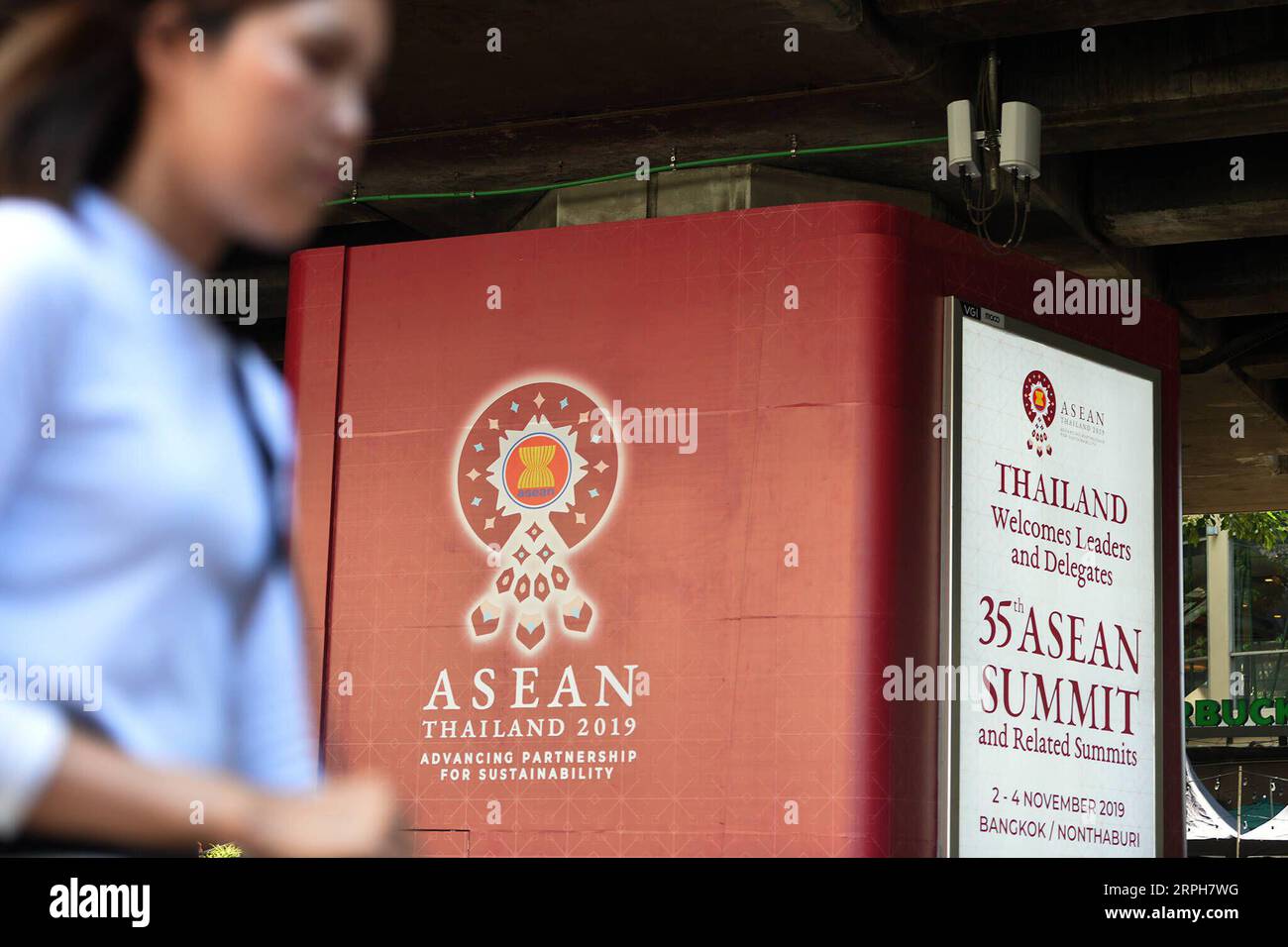 191101 -- BANGKOK, Nov. 1, 2019 -- A woman passes by a poster of the 35th ASEAN summit and related summits in Bangkok, Thailand, Oct. 30, 2019. The 35th ASEAN summit and related summits are scheduled for Nov. 2 to 4 in Bangkok. Rachen Sageamsak THAILAND-BANGKOK-ASEAN SUMMIT-PREPARATION LaxHeng PUBLICATIONxNOTxINxCHN Stock Photo