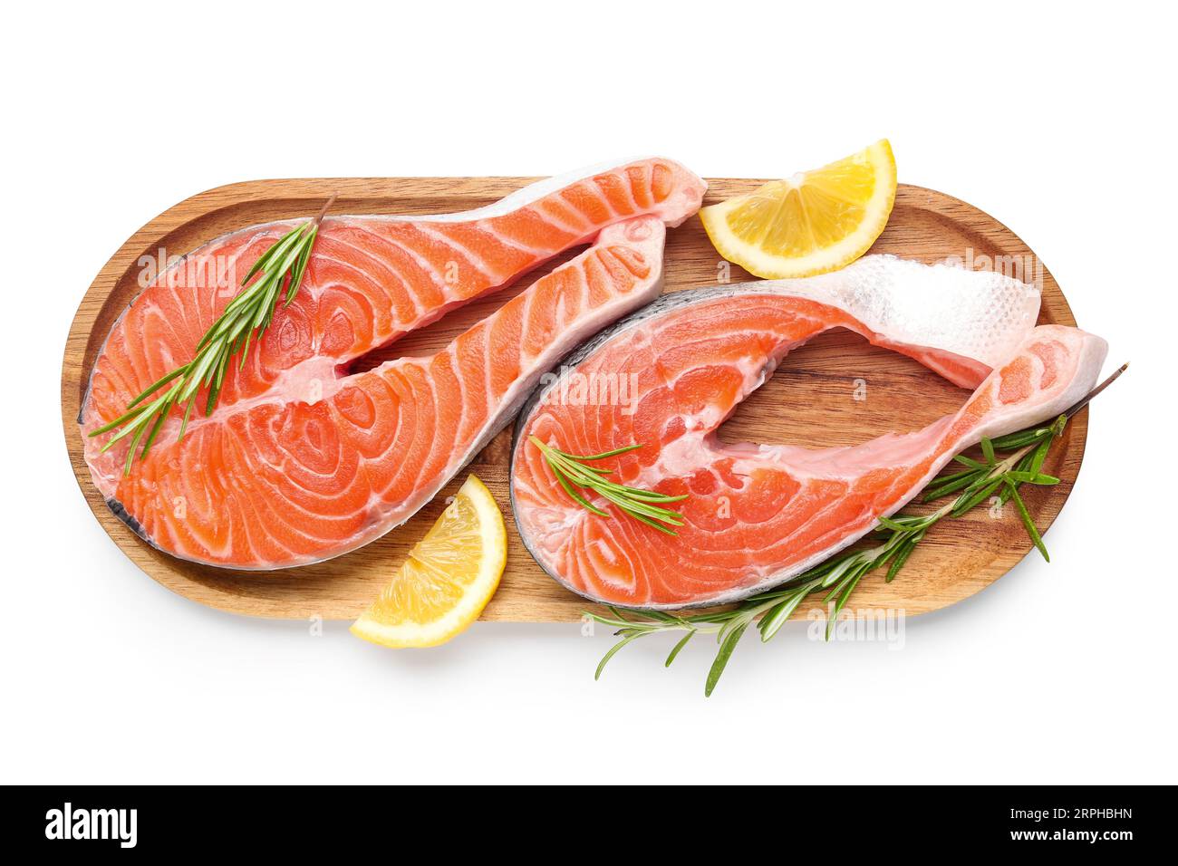 Wooden board with raw salmon steaks and different spices on white ...