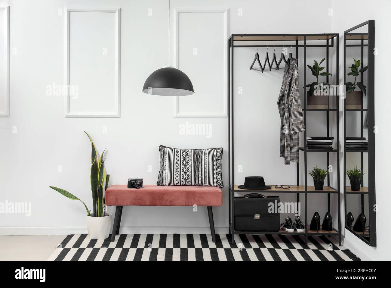 Interior of stylish hall with soft bench and clothes rack Stock Photo ...