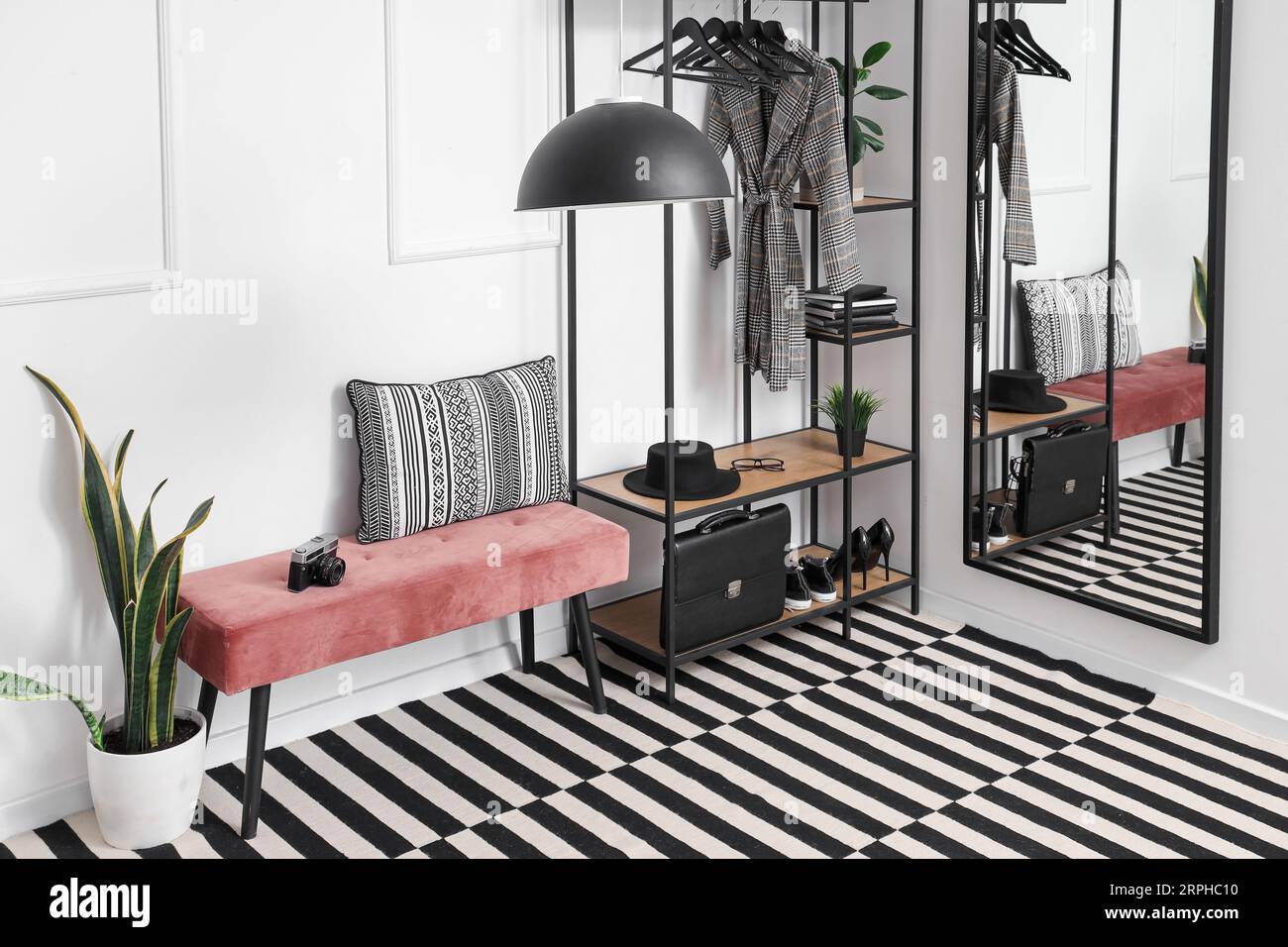 Interior of stylish hall with soft bench and clothes rack Stock Photo ...