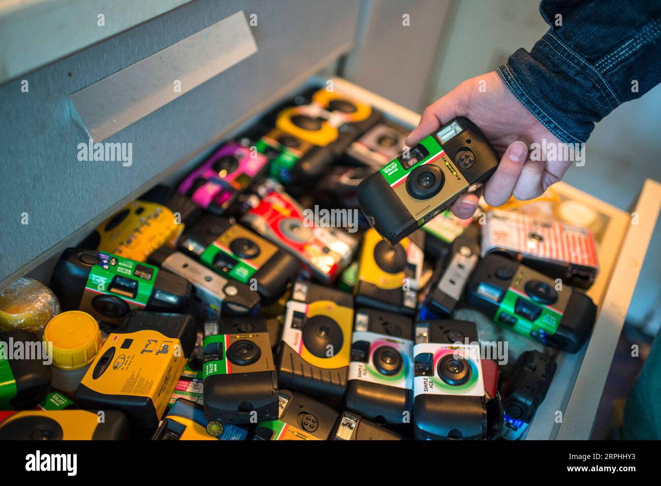191109 -- BEIJING, Nov. 9, 2019 -- Liu Gaochao shows a collection of used disposable cameras from customers at his studio in Beijing, capital of China, Oct. 26, 2019. It s been more than five years since Liu Gaochao embraced a career in film developing. On top of a high-rise mansion next to Liufang Station of Beijing Subway Line 13, Liu runs a studio, New Wave Film Lab, which also provides him a place to live. In 2012, Liu left his hometown in central China s Henan Province and headed for Beijing in pursuit of better opportunities. After he settled down in the capital city, he came across film Stock Photo