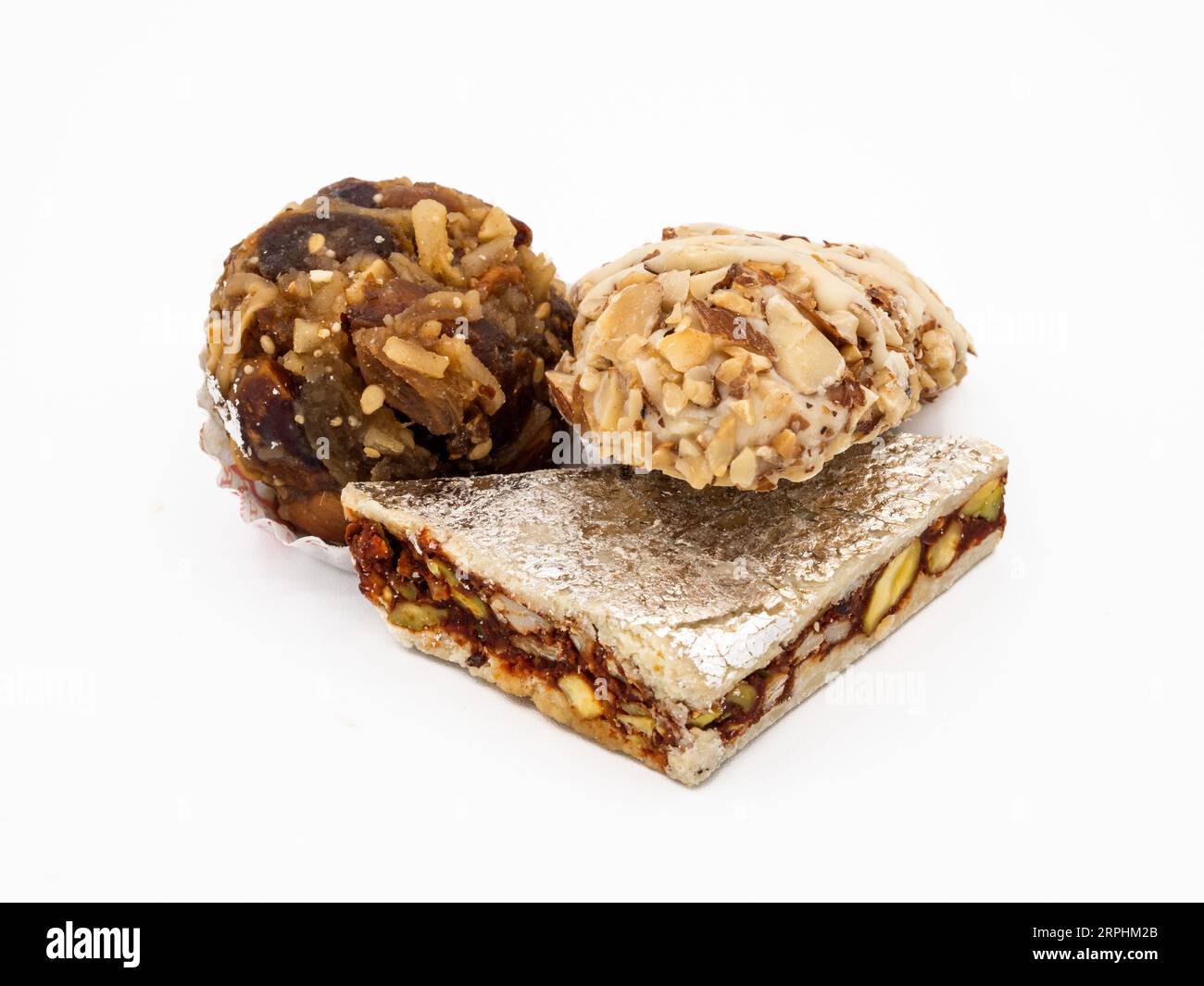 Three varieties of pure ghee sweets from India, each with its own flavor and texture, isolated