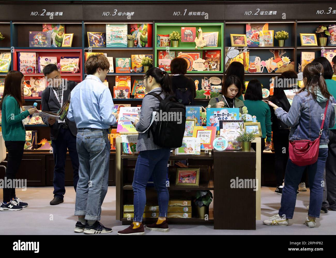 191115 -- SHANGHAI, Nov. 15, 2019 -- People select books during the 2019 China Shanghai International Children s Book Fair CCBF at Shanghai World Expo Exhibition and Convention Center in Shanghai, east China, Nov. 15, 2019. The 2019 China Shanghai International Children s Book Fair CCBF kicked off here on Friday. The three-day event bring together more than 400 exhibitors from over 30 countries and regions, including publishing houses, distributors, toymakers and training agencies.  CHINA-SHANGHAI-INT L CHILDREN S BOOK FAIR CN LiuxYing PUBLICATIONxNOTxINxCHN Stock Photo
