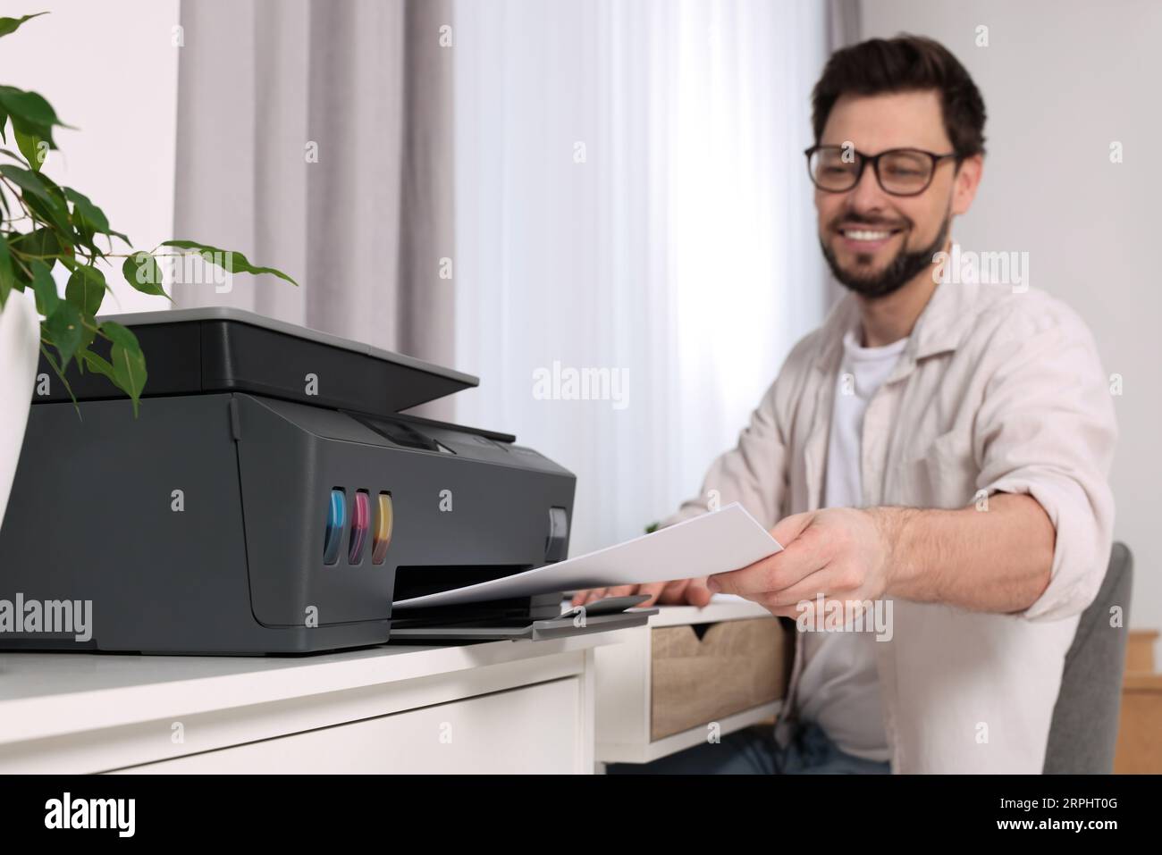 Man using modern printer at workplace indoors, selective focus Stock ...