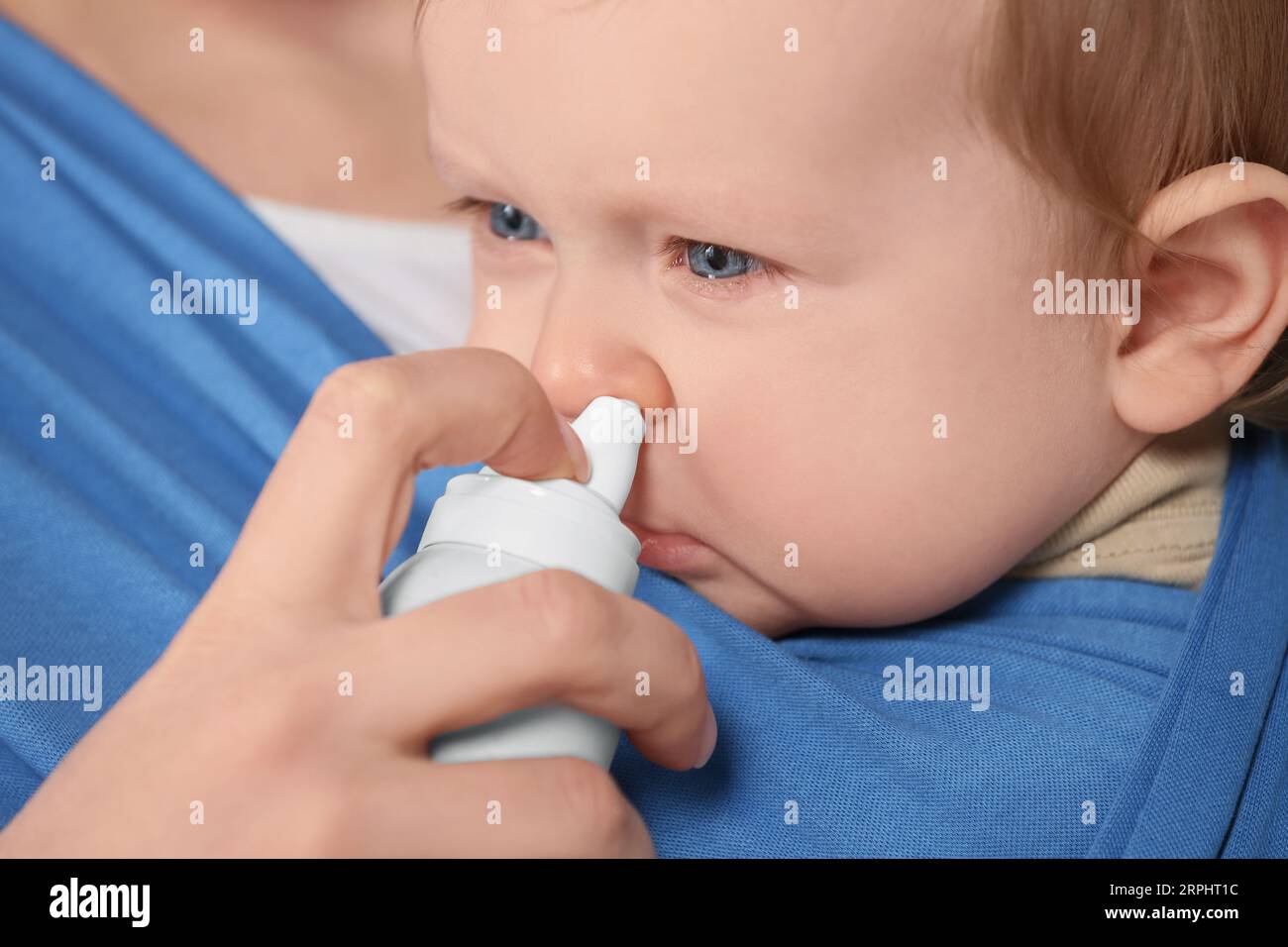 Mother helping her baby to use nasal spray, closeup Stock Photo Alamy