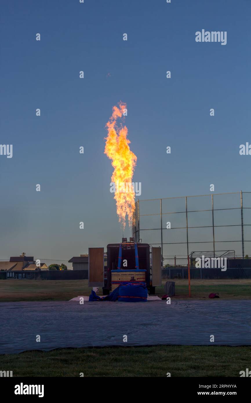 A bright flame from a propane gas engine is shooting into the air. They ...