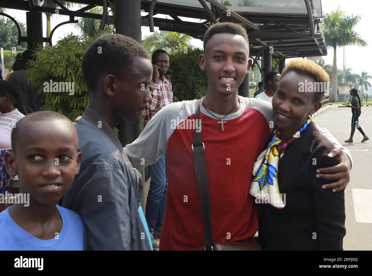 191121 -- BEIJING, Nov. 21, 2019 -- Mike Manzi C, a Rwandan student, bids farewell to his family and friends before departing for China to attend an undergraduate program at the Alibaba Business School at Kigali International Airport in Kigali, Rwanda, on Sept. 9, 2019.  Xinhua Headlines: Growing amid daunting challenges, African e-commerce expects inspiration from Chinese partners LyuxTianran PUBLICATIONxNOTxINxCHN Stock Photo