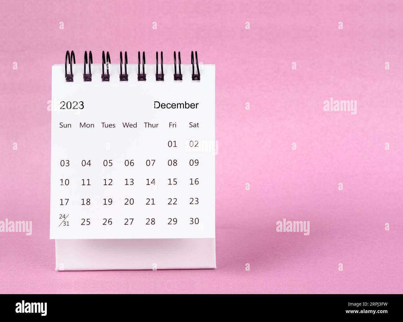 The December 2023 desk calendar on pink color background Stock Photo - Alamy