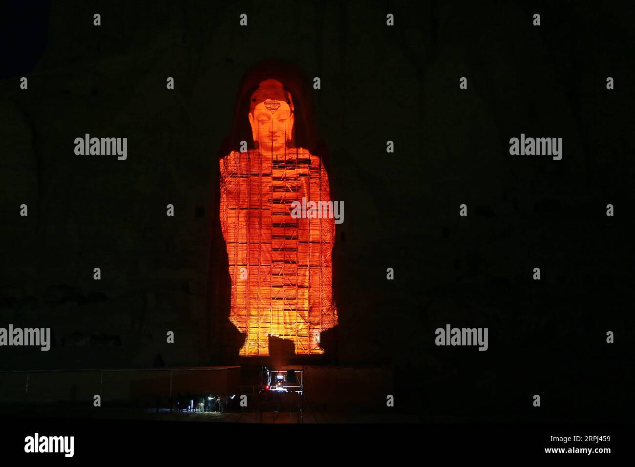 191126 -- BAMYAN, Nov. 26, 2019 -- Photo taken on Nov. 25, 2019 shows the projection of the Bamyan Buddha in orange color to commemorate the International Day for the Elimination of Violence Against Women in Bamyan province, central Afghanistan. Photo by /Xinhua AFGHANISTAN-BAMYAN-INTERNATIONAL DAY FOR THE ELIMINATION OF VIOLENCE AGAINST WOMEN-COMMEMORATION NoorxAzizi PUBLICATIONxNOTxINxCHN Stock Photo