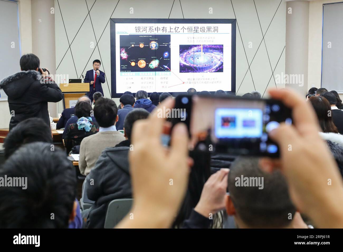 191128 -- BEIJING, Nov. 28, 2019 -- Liu Jifeng, deputy director-general of the National Astronomical Observatory of the Chinese Academy of Sciences NAOC and the first author of the study, speaks during a press conference of the black hole LB-1 discovered with the Large Sky Area Multi-Object Fibre Spectroscopy Telescope LAMOST, in Beijing, capital of China, Nov. 27, 2019. A Chinese-led research team has discovered a surprisingly huge stellar black hole about 14,000 light years from Earth -- our backyard of the universe -- forcing scientists to re-examine how such black holes form. The team, hea Stock Photo