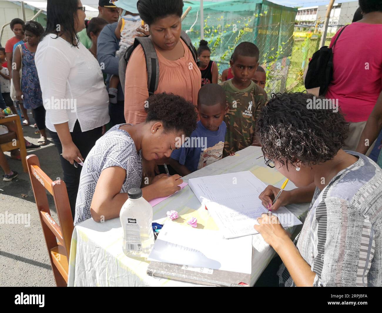 191204 -- SUVA, Dec. 4, 2019 -- Residents register before receiving measles vaccine in Suva, Fiji, Dec. 4, 2019. The second phase of the measles immunization campaign began on Wednesday in Fiji s capital Suva. The immunization campaign targets children who have not received two doses of the measles vaccine, any child aged 12 and 18 months who is due for immunization, people travelling overseas, healthcare workers, and airport and hotel staff around the country. There are 15 confirmed measles cases in Fiji by Tuesday.  FIJI-SUVA-MEASLES IMMUNIZATION ZhangxYongxing PUBLICATIONxNOTxINxCHN Stock Photo