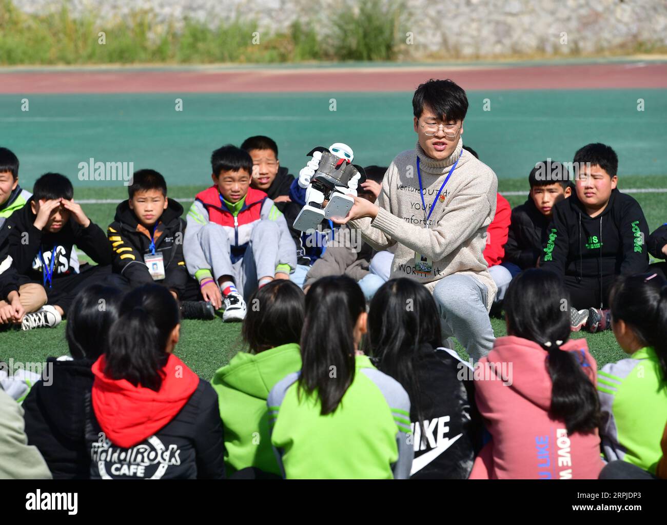 191206 -- RONGSHUI, Dec. 6, 2019 -- Tan Botian, a postgraduate student of Northwestern Polytechnical University NPU who volunteers here as a head teacher, gives a science and technology class to students at Siyuan Experimental School in Rongshui Miao Autonomous County, south China s Guangxi Zhuang Autonomous Region, Dec. 5, 2019. Rongshui is among the 20 deeply impoverished counties in south China s Guangxi. Off its 115 poor villages, 73 are deeply impoverished. Since 2015, the NPU has launched educational assistance to the county where education level is low. Relying on its S&T as well as edu Stock Photo