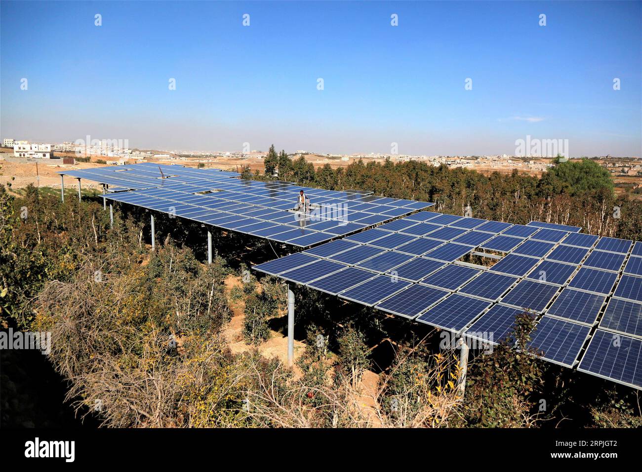 191210 SANAA, Dec. 10, 2019 A man checks solar panels installed