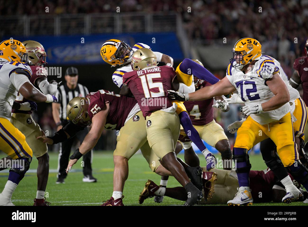 LSU quarterback Jayden Daniels (5) is hit by Florida State linebacker Tatum Bethune (15) after
