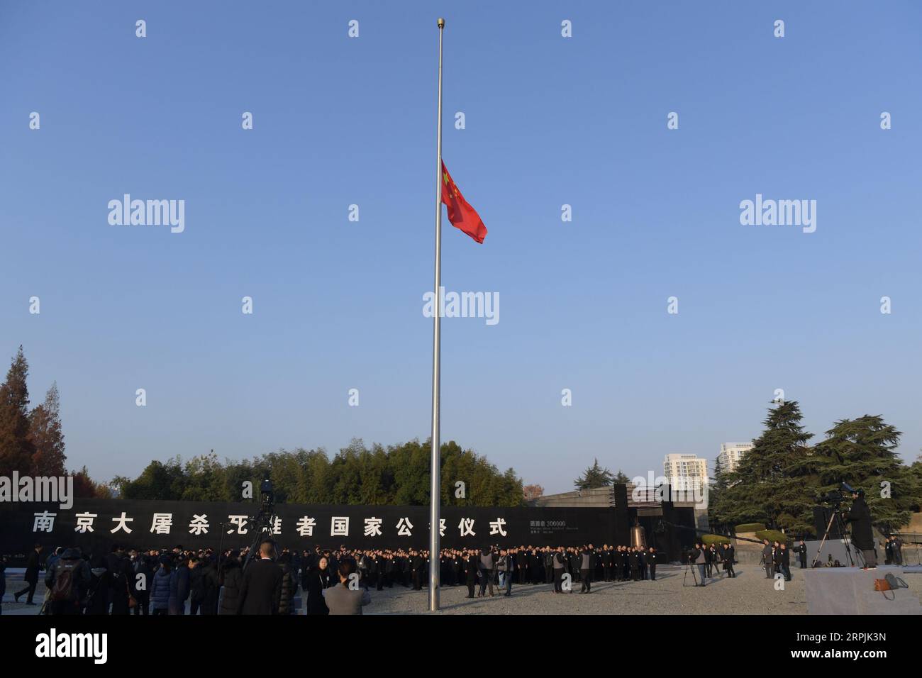 191213 -- NANJING, Dec. 13, 2019 -- China s national flag flies at half-mast during a national memorial ceremony to commemorate the victims of the Nanjing Massacre at the memorial hall for the massacre victims in Nanjing, east China s Jiangsu Province, Dec. 13, 2019.  CHINA-NANJING MASSACRE VICTIMS-NATIONAL MEMORIAL CEREMONY CN LixBo PUBLICATIONxNOTxINxCHN Stock Photo