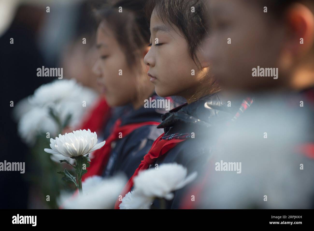 191213 -- NANJING, Dec. 13, 2019 -- Pupils mourn during a ceremony to mark China s sixth National Memorial Day for Nanjing Massacre victims at the Monument for the victims killed at the Zhongshan Dock in the massacre in Nanjing, east China s Jiangsu Province, Dec. 13, 2019.  CHINA-NANJING MASSACRE VICTIMS-NATIONAL MEMORIAL CEREMONY CN LixYuze PUBLICATIONxNOTxINxCHN Stock Photo