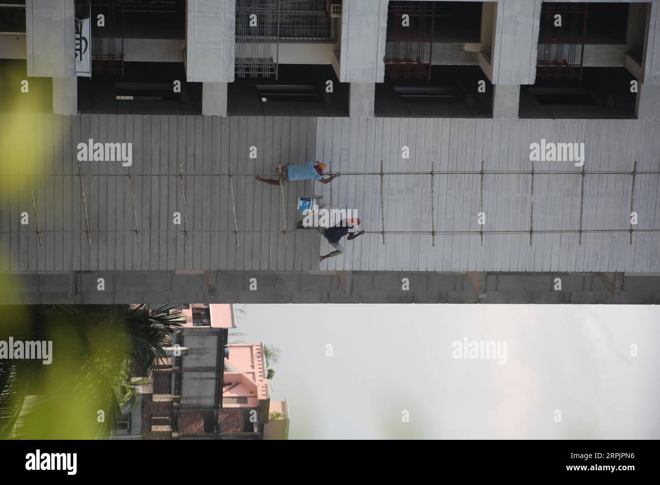 DHAKA Bangladesh September 05,2023. Workers paint a highrise building