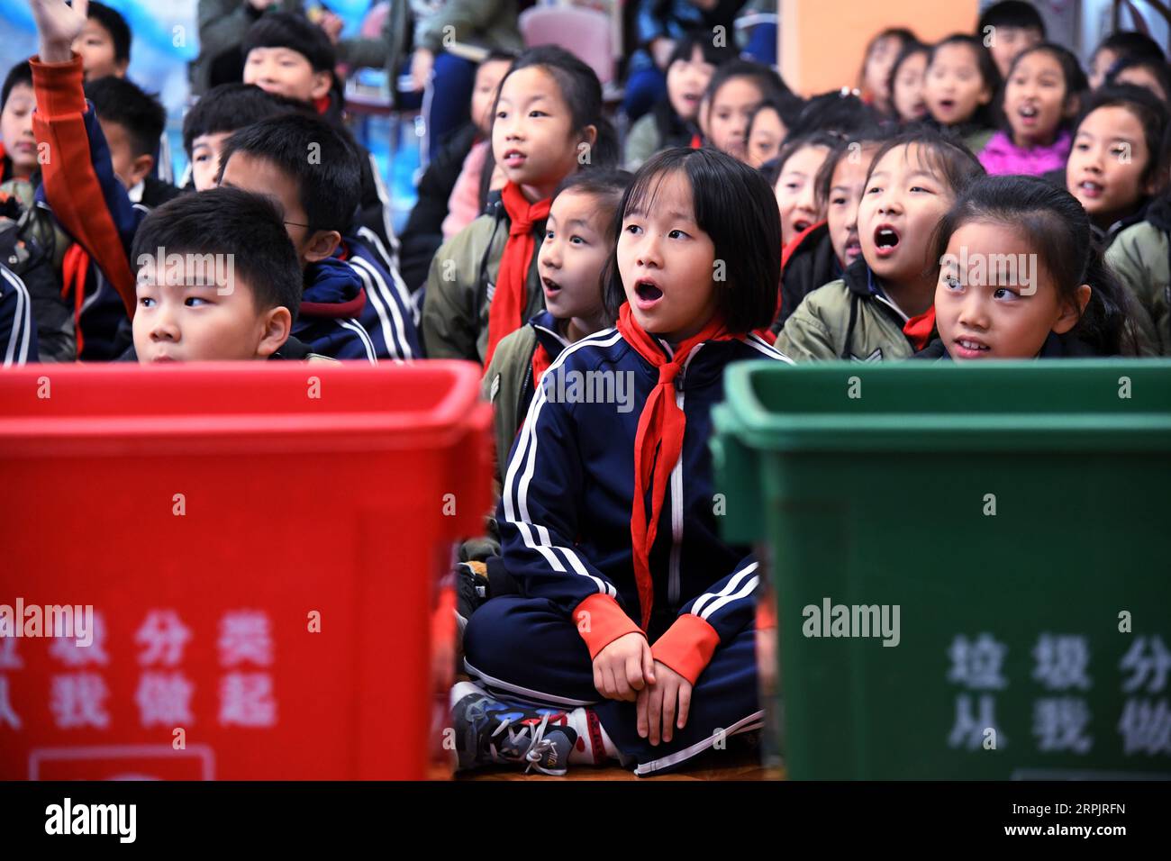 191218 -- QINGDAO, Dec. 18, 2019 -- Pupils learn about garbage classification at the Juyuan Primary School in Qingdao City, east China s Shandong Province, Dec. 18, 2019. Youth volunteers for social service from the Qingdao Zhanqiao Bookstore launched a scientific information outreach program at the Juyuan Primary School Wednesday. Through video clips, knowledge contests, short dramas and amusing games, the volunteers attempted to help the pupils better understand the necessity of garbage classification as well as the importance of environmental and ecological protection.  CHINA-SHANDONG-QINGD Stock Photo
