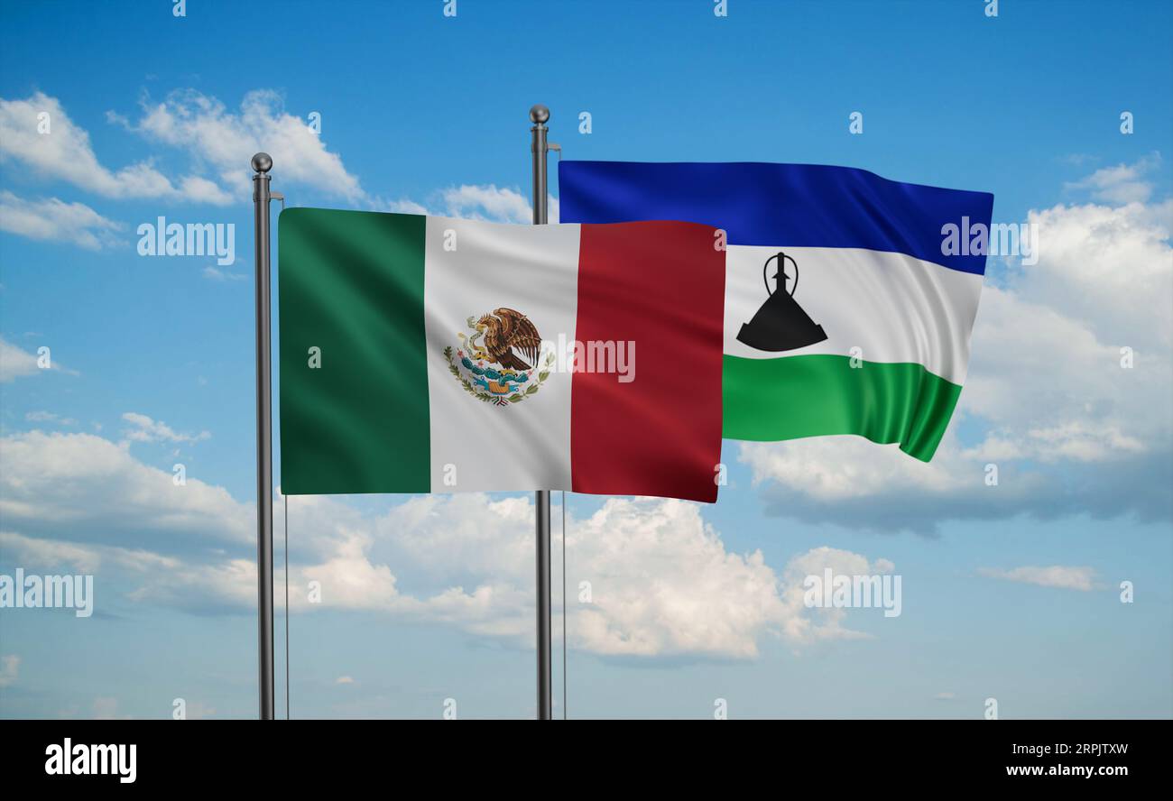 Lesotho and Mexico flag waving together in the wind on blue sky, two ...