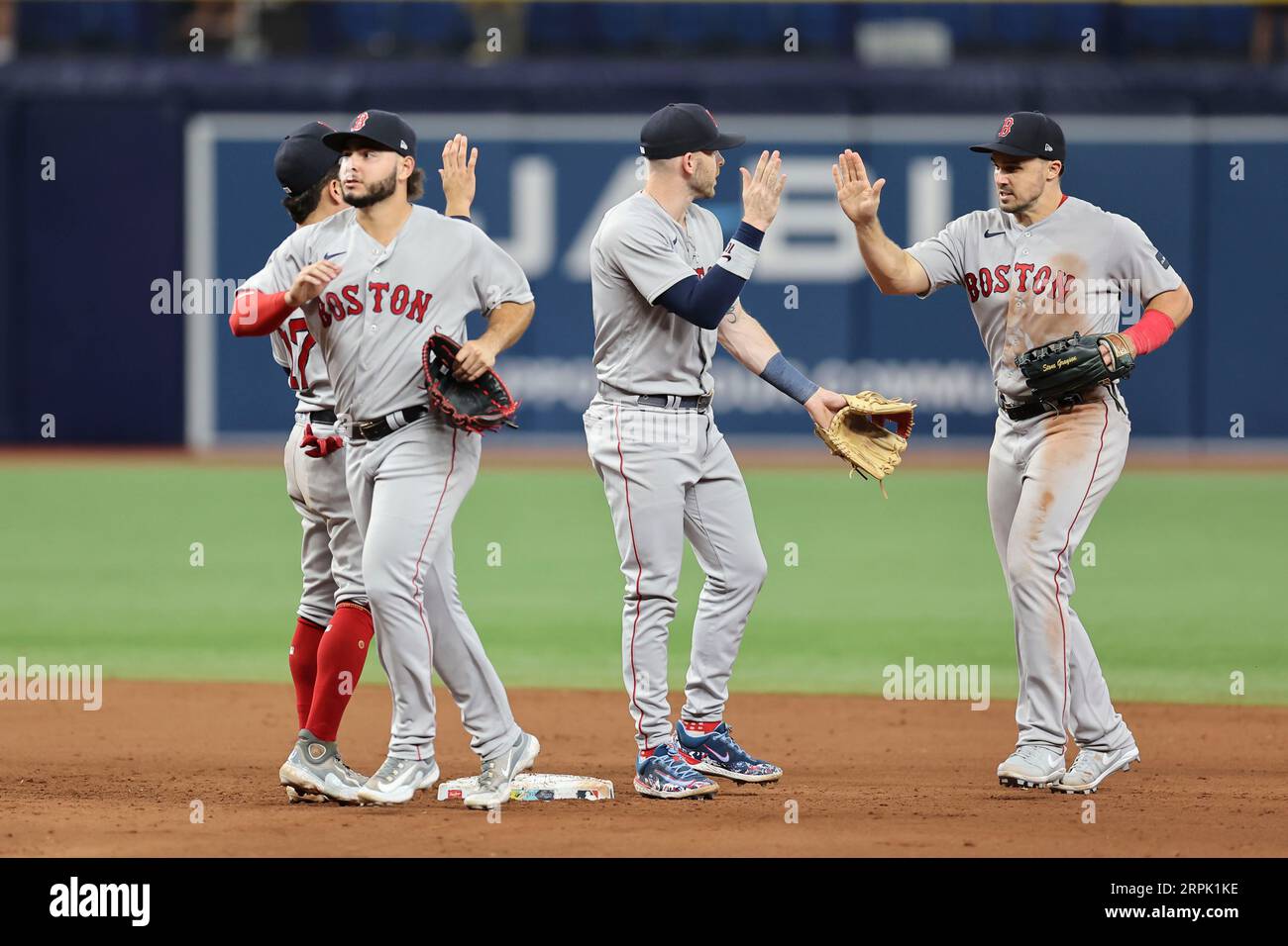 St. Petersburg, FL USA; Handshakes for the winners as Boston Red Sox players give high fives as they head to the dugout after an MLB game against the Stock Photo