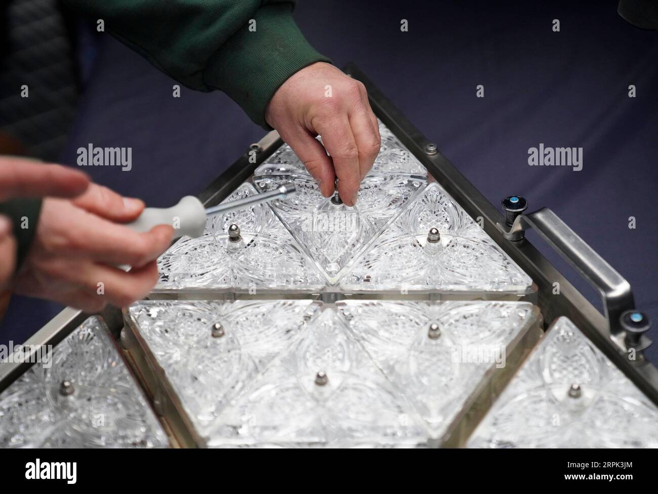 191227 -- NEW YORK, Dec. 27, 2019 -- A worker installs a new crystal triangle to a panel on the roof of the One Times Square building in New York City, the United States, on Dec. 27, 2019. The iconic New Year s Eve Ball in New York City s Times Square had its latest decoration done on Thursday for the upcoming celebrations, featuring Gift of Goodwill design. Workers installed 192 new sparkling crystal triangles onto the ball for replacement. Covered with a total of 2,688 Waterford Crystal triangles, the ball is 12 feet 3.66 meters in diameter and weighs 11,875 pounds 5386.4 kilograms.  U.S.-NE Stock Photo