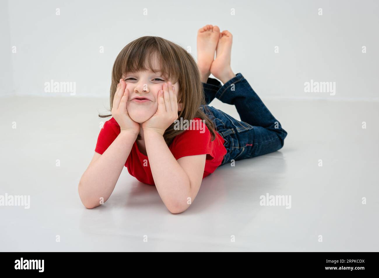 Happy girl lying on floor hi-res stock photography and images - Alamy