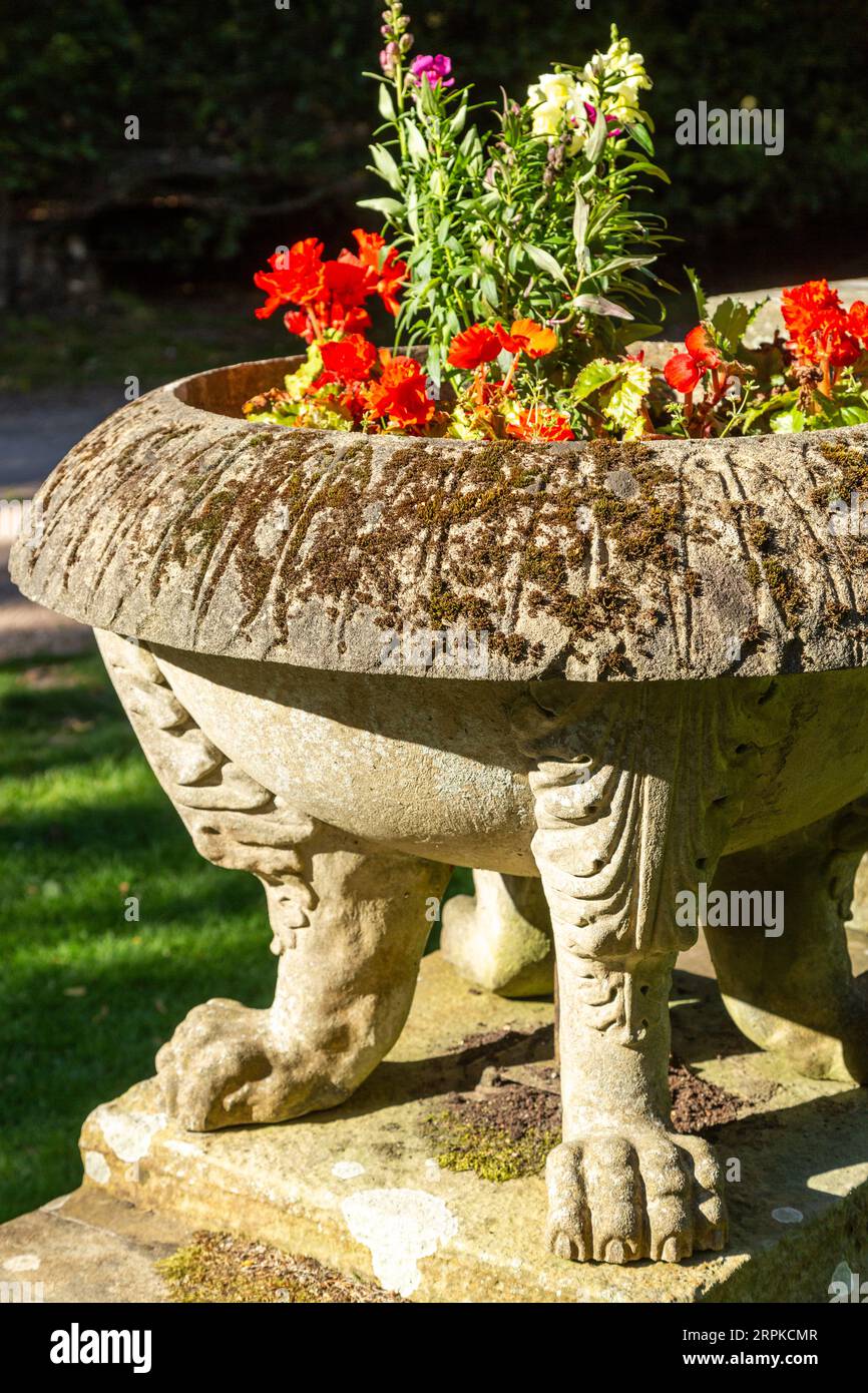 ornate stone planter with carved lions feet Stock Photo