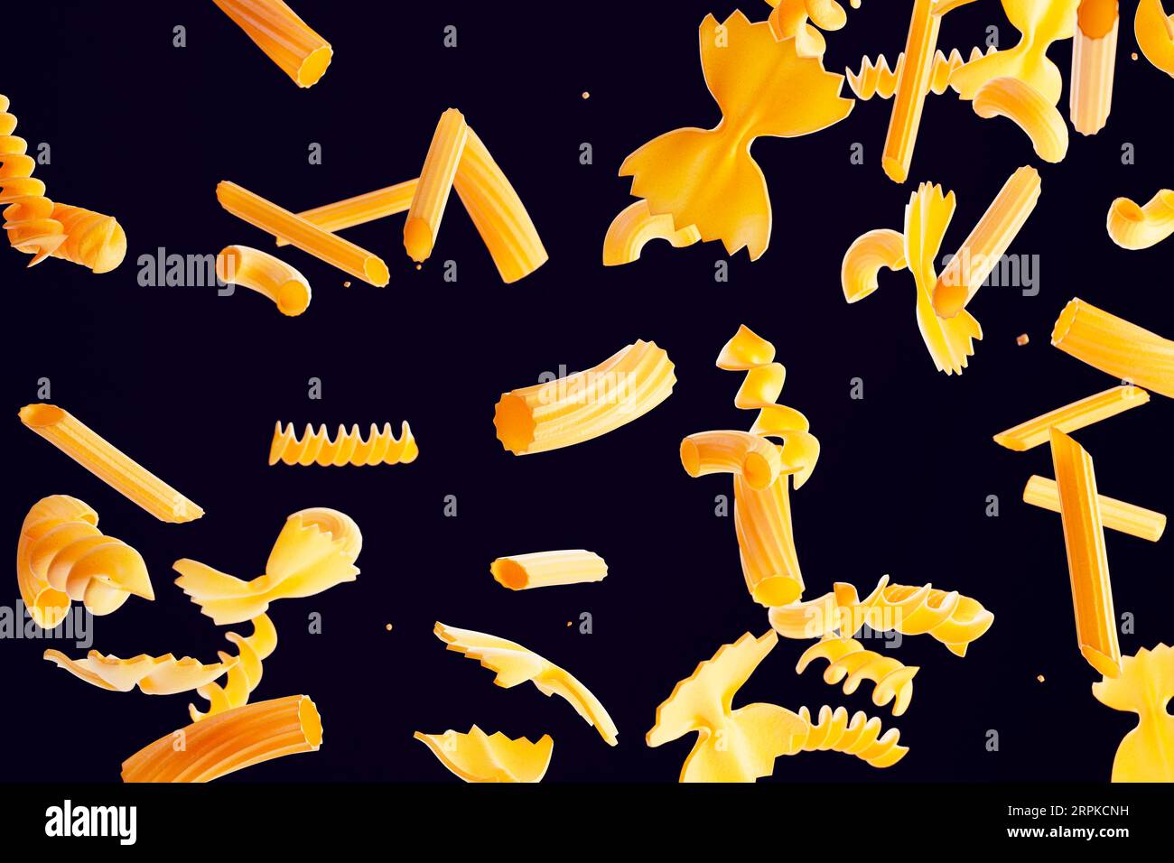 A variety of raw pasta shapes captured in mid-air. High-speed photography Stock Photo
