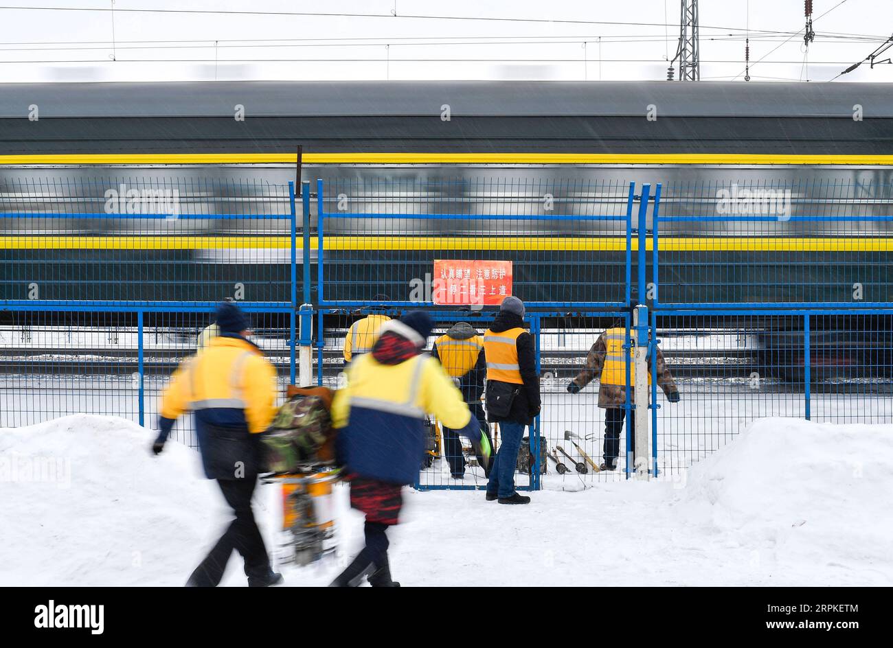 200109 -- CHANGCHUN, Jan. 9, 2020 -- Wang Chao L and other rail flaw detectors from the Changchun section of China Railway Shenyang Group Co., Ltd. carry devices before flaw detection operations in northeast China s Jilin Province, Jan. 8, 2020. The work of Wang and his seven-member team is 38.5-kilometer-long rail flaw detection of Beijing-Harbin railway. Equipped with ultrasonic devices, flaw detectors can inspect and eliminate potential rail safety hazards efficiently. The lowest temperature in Jilin dropped to minus 20 degrees Celsius recently. As cold weather might cause subtle physical i Stock Photo