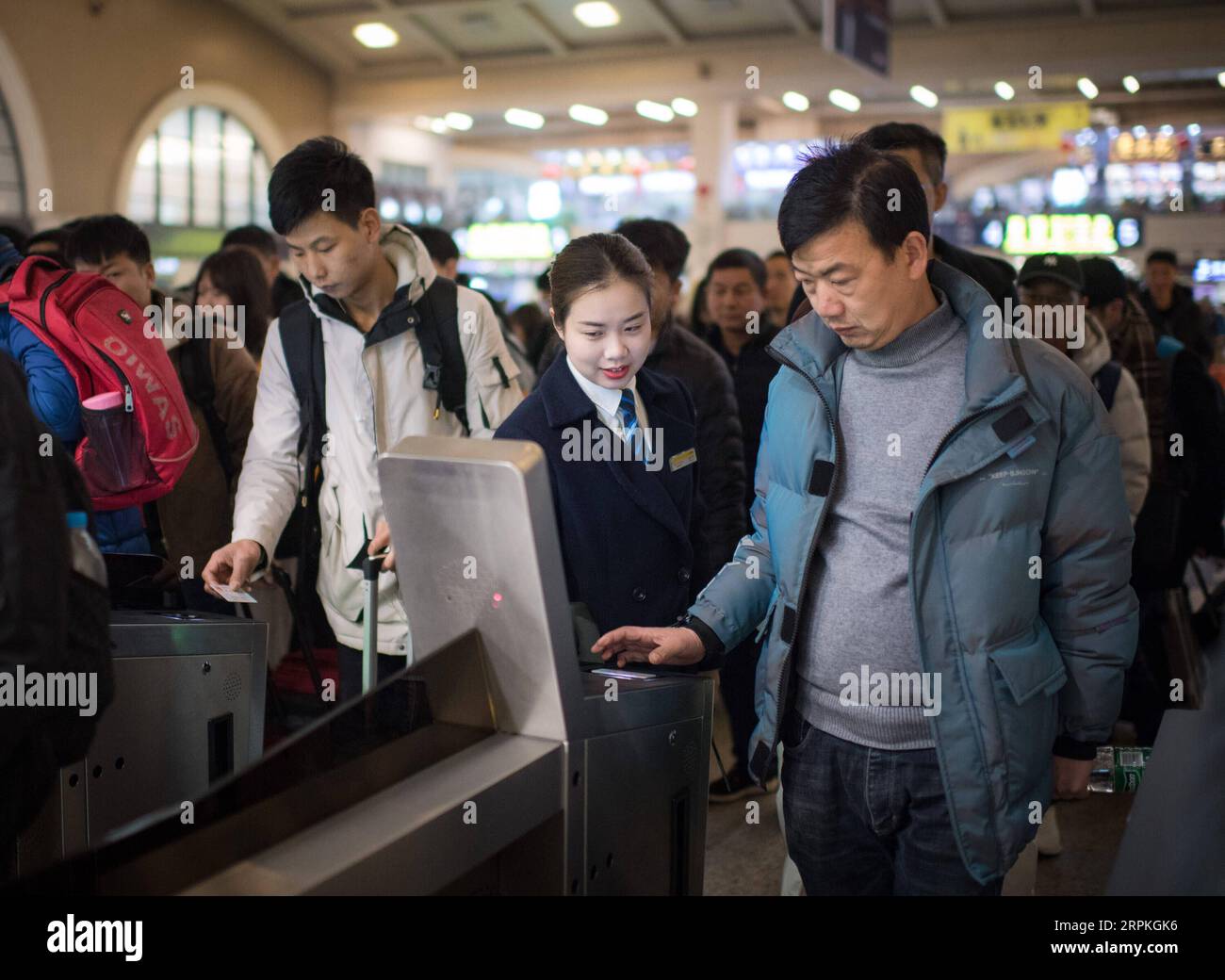 200111 -- WUHAN, Jan. 11, 2020 -- Sun Fanjun C, a ticket inspector, guides passengers through ticket gates at Hankou Railway Station in Wuhan, central China s Hubei Province, Jan. 5, 2020. China, the world s most populated country, on Jan. 10 ushered in its largest annual migration, 15 days ahead of the Spring Festival, or the Lunar New Year. This year, three billion trips will be made during the travel rush from Jan. 10 to Feb. 18 for family reunions and travel, according to official forecast. The 40-day travel rush is known as Chunyun in Chinese. The Lunar New Year falls on Jan. 25 this year Stock Photo