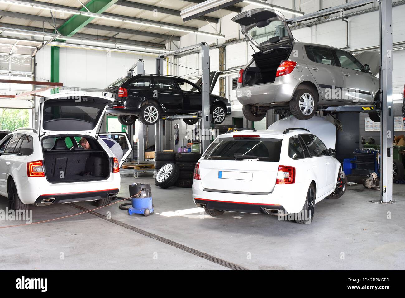 Cars for maintenance and repair in a workshop on the lift Stock Photo