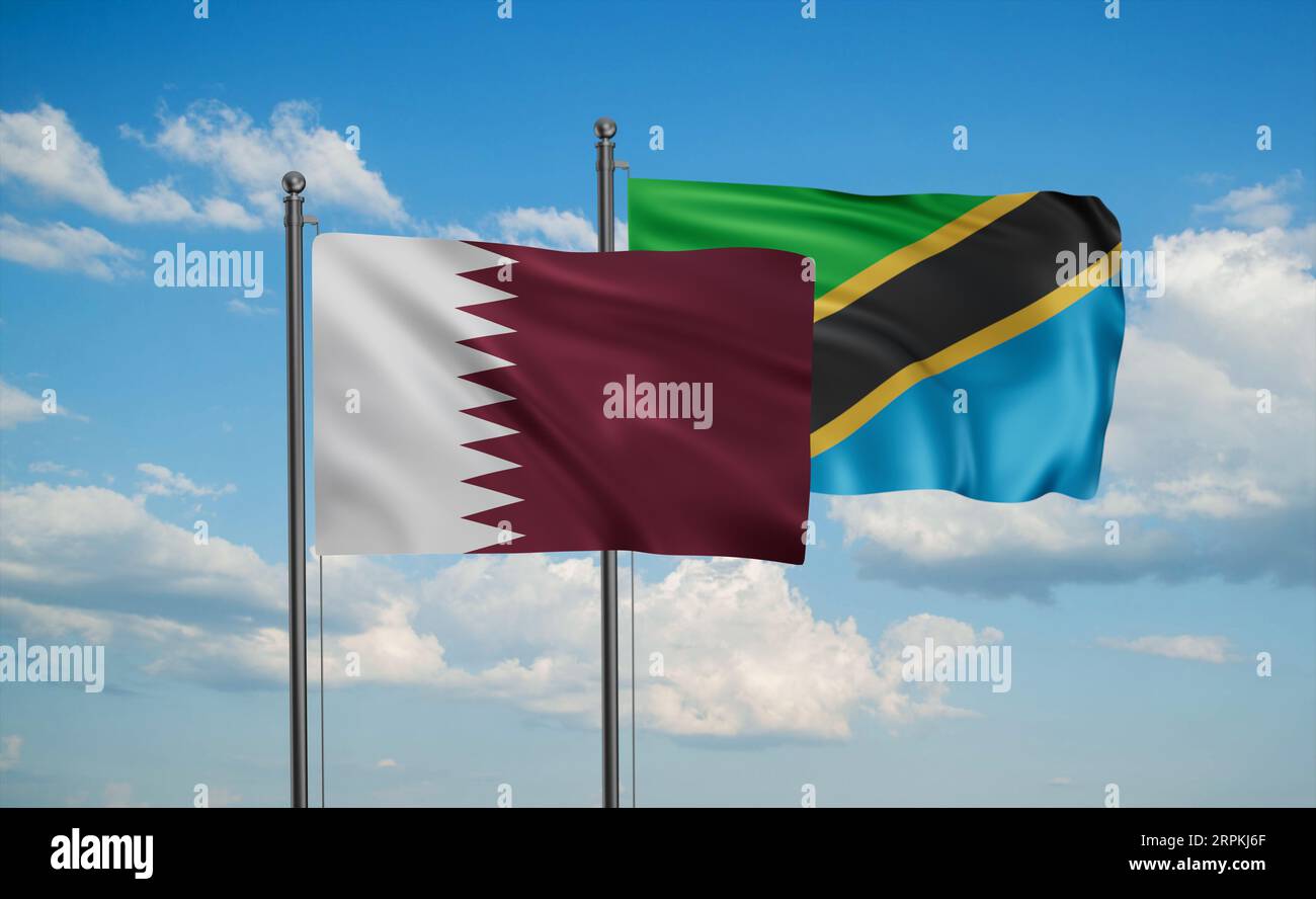 Tanzania and Qatar flag waving together in the wind on blue sky, two ...