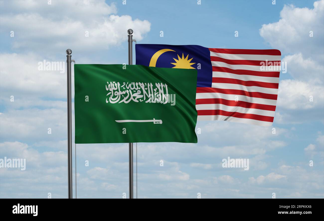 Malaysia and Saudi Arabia, KSA flag waving together in the wind on blue sky, two country cooperation concept Stock Photo