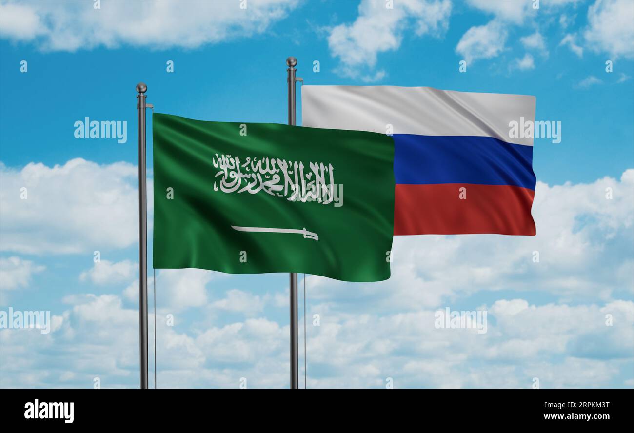 Russian Federation and Saudi Arabia, KSA flag waving together in the wind on blue sky Stock Photo