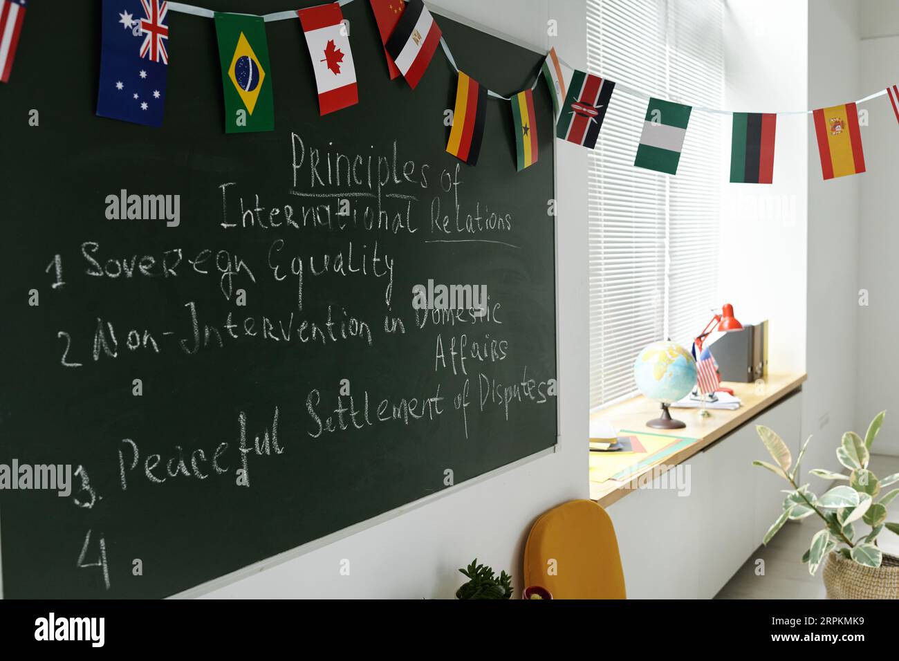 Blackboard with flags of different countries in the classroom at school