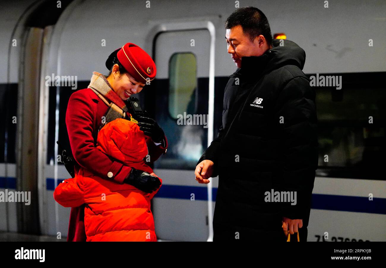 200121 -- SHIJIAZHUANG, Jan. 21, 2020 -- Zhang Anzhe hugs his mother at a railway station in Shijiazhuang, north China s Hebei Province, Jan. 21, 2020. The Spring Festival is the biggest occasion for family reunion across China, but for the family of 6-year-old Zhang Anzhe, reunion opportunities are rare. Zhang s father Zhang Peng is a policeman working at the Shijiazhuang Railway Station police office while his mother Li Qi is a chief conductor on trains between Shijiazhuang and Wuhan. Both parents were so busy during the Spring Festival travel rush period. They have to make use of every bit Stock Photo