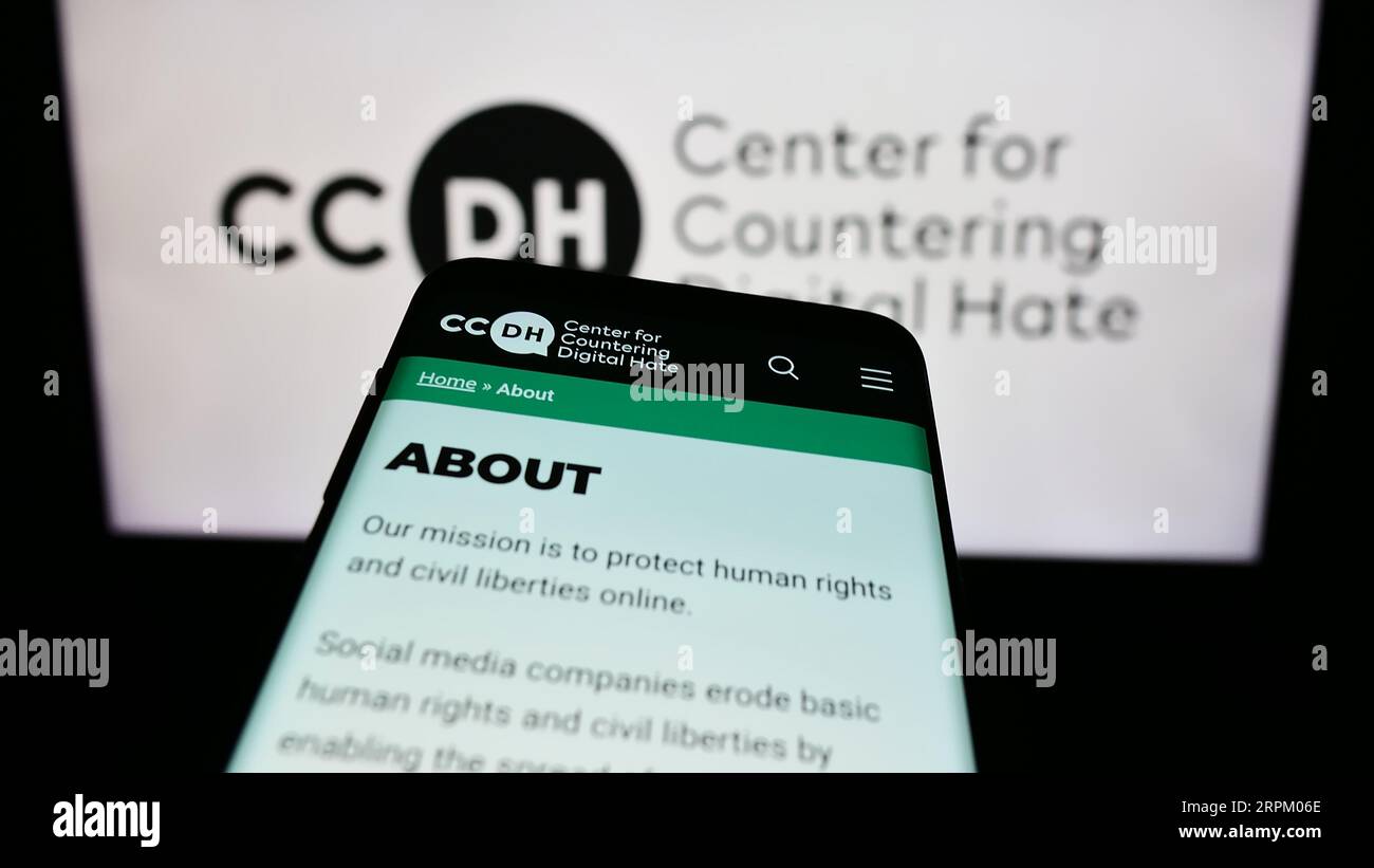 Mobile phone with website of Center for Countering Digital Hate (CCDH) on screen in front of logo. Focus on top-left of phone display. Stock Photo