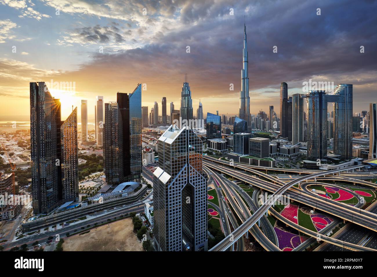 Fantastic rooftop view of Dubai's modern architecture by night with illuminated skyscrapers, UAE