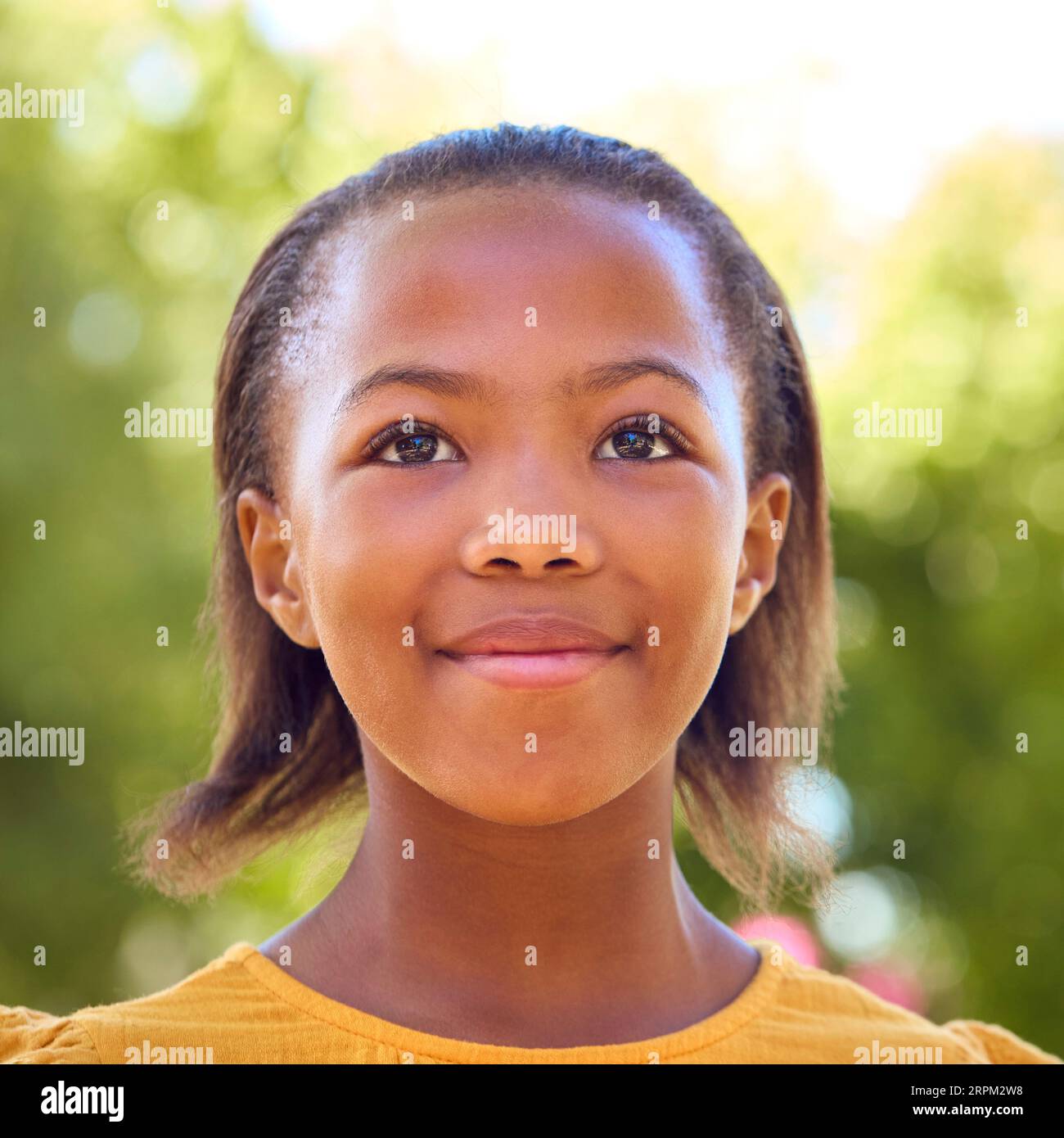 Portrait Of Smiling Young Girl Standing Outdoors In Summer Garden Park Or Countryside Stock Photo