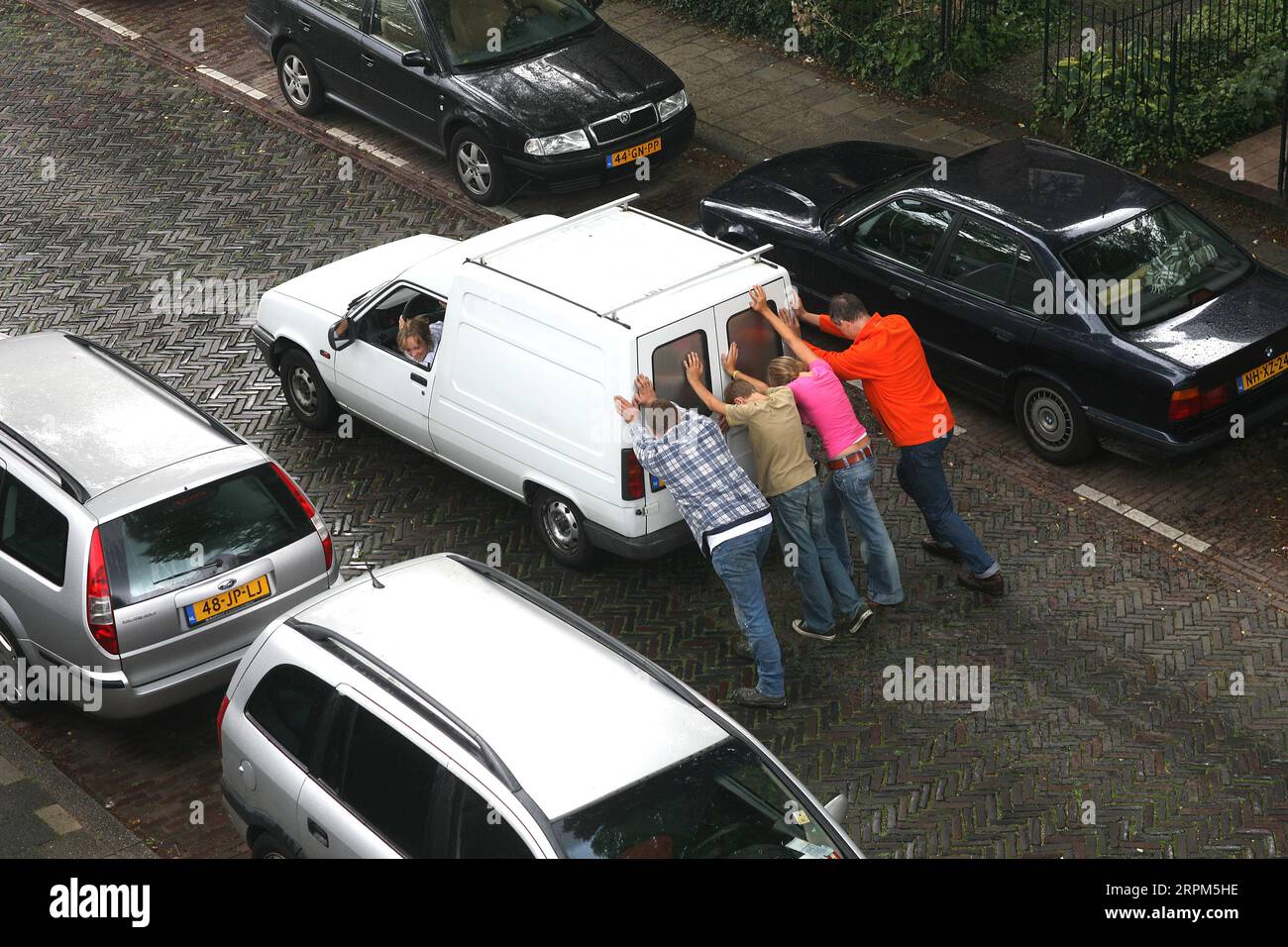 Netherlands, Car is pushed to start the engine, because the battery failed. Stock Photo