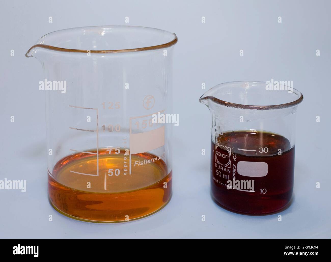 two liquid polymers in measuring cups added together gives chemical a  reaction Stock Photo - Alamy