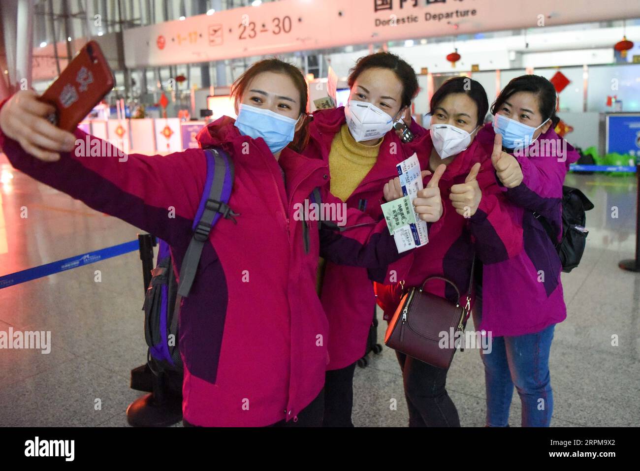 200205 -- URUMQI, Feb. 5, 2020 -- Medical team members take a selfie before leaving for Wuhan, the epicenter of the coronavirus outbreak, at Diwopu International Airport in Urumqi, northwest China s Xinjiang Uygur Autonomous Region, Feb. 4, 2020. The second batch of a medical team comprised of 102 members from Xinjiang left for Wuhan on Tuesday to aid the novel coronavirus control efforts there. So far, Xinjiang has sent a total of 244 medics to Wuhan.  CHINA-XINJIANG-MEDICAL TEAM-AID-SECOND BATCH CN DingxLei PUBLICATIONxNOTxINxCHN Stock Photo
