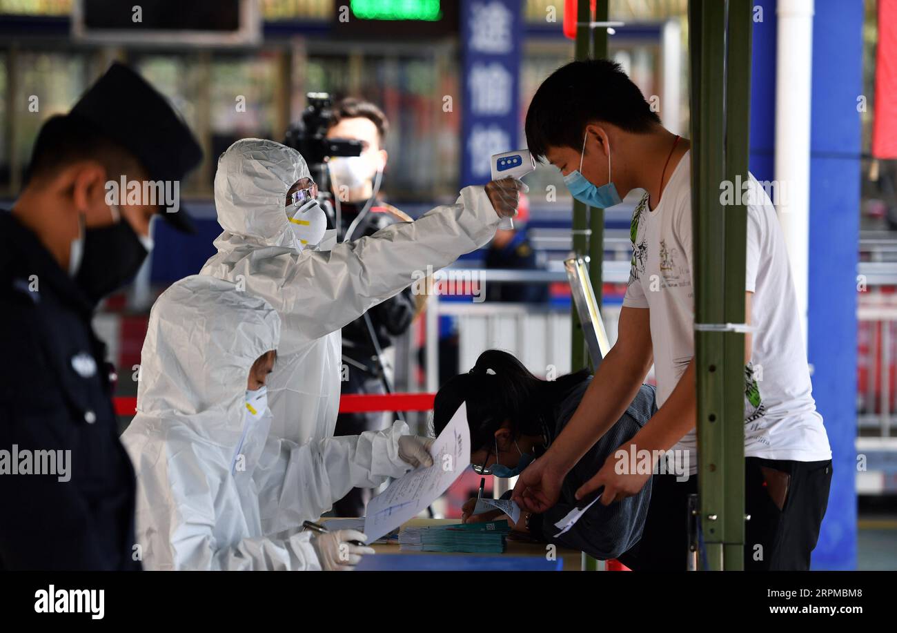 200207 -- HAIKOU, Feb. 7, 2020 -- A medical staff member from Haikou of south China s Hainan Province measures body temperature of a passenger in Xuwen County of Zhanjiang City, south China s Guangdong Province, Feb. 6, 2020. Qiongzhou Strait is a major passage into and out of Hainan Island. Since the start of the prevention and control of pneumonia caused by the novel coronavirus, Hainan and Guangdong have both moved the prevention and control threshold forward. Hainan has sent more than 160 joint anti-epidemic personnel from multiple departments to Zhanjiang of Guangdong Province, and set up Stock Photo