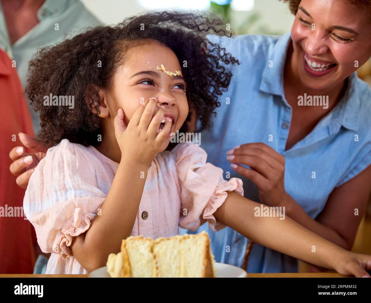 Granddaughter Making Mess With Cake As Multi-Generation Family ...